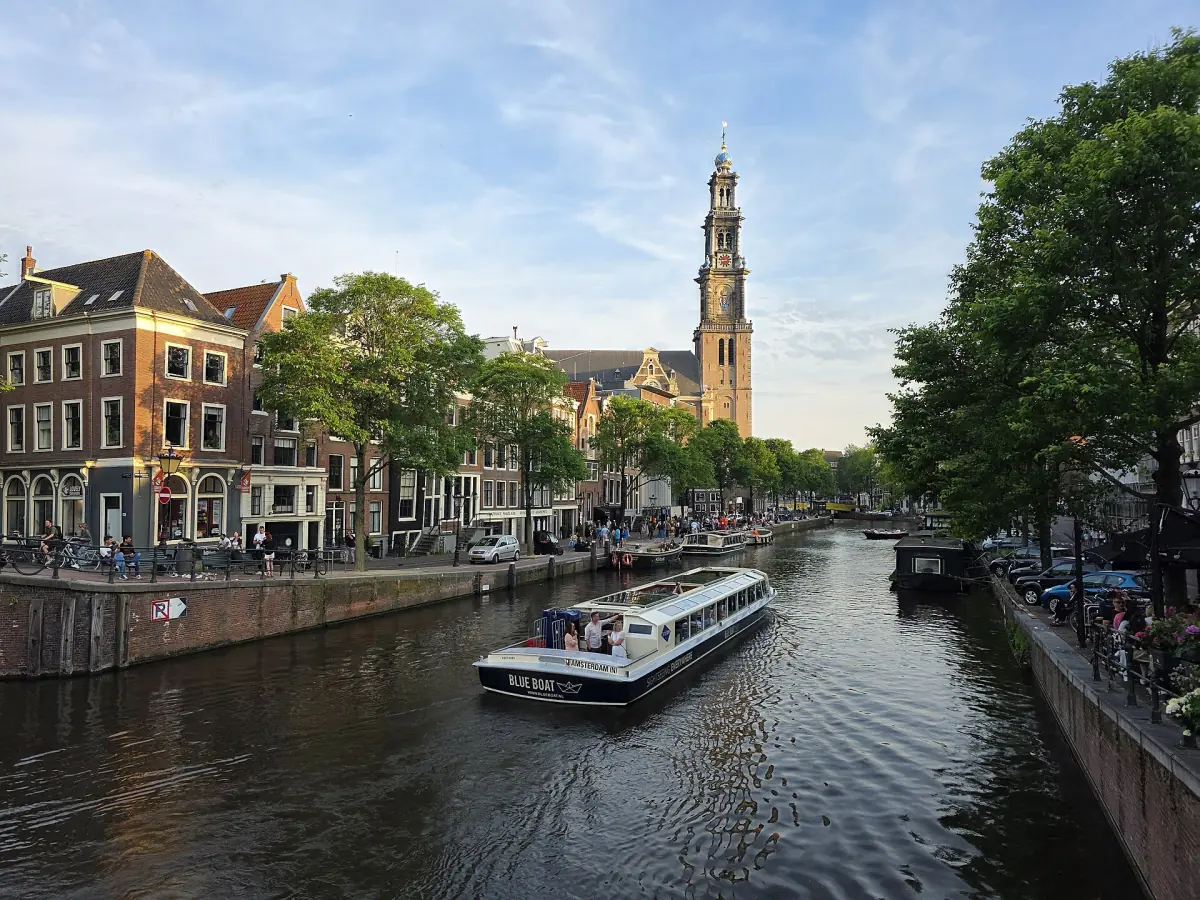 A canal boat with the Westerkerk behind
