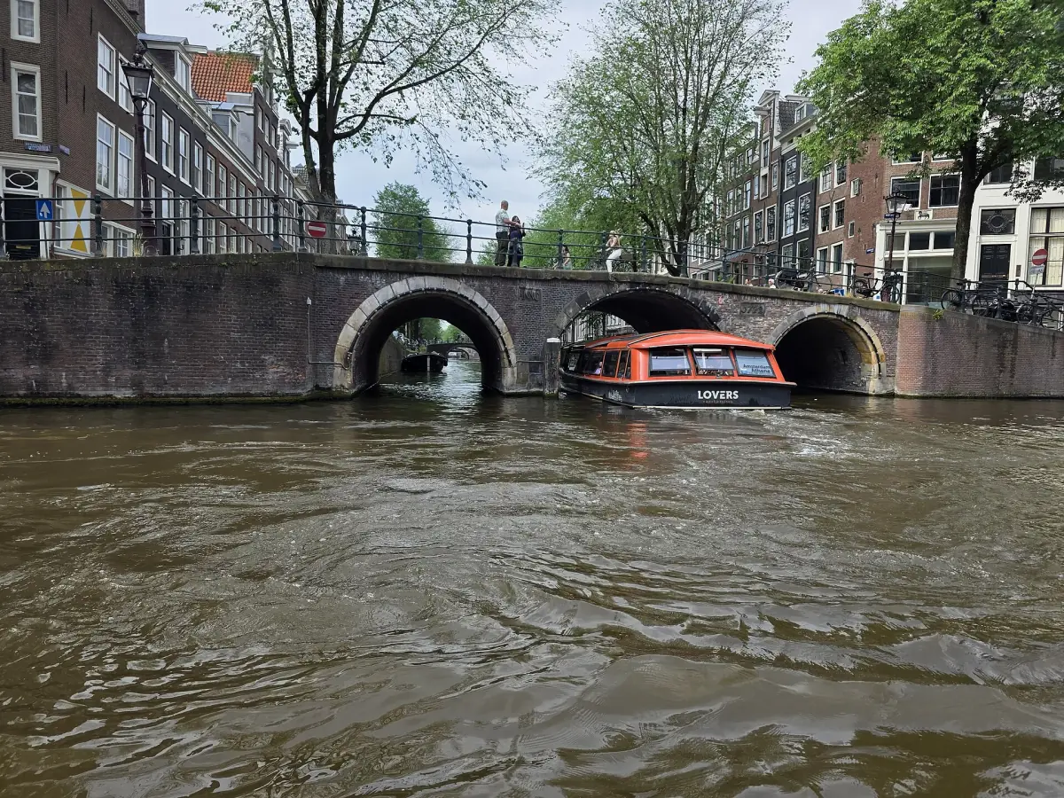 A boat passing under a bridge